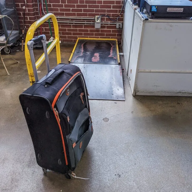 A black suitcase with red detailing.