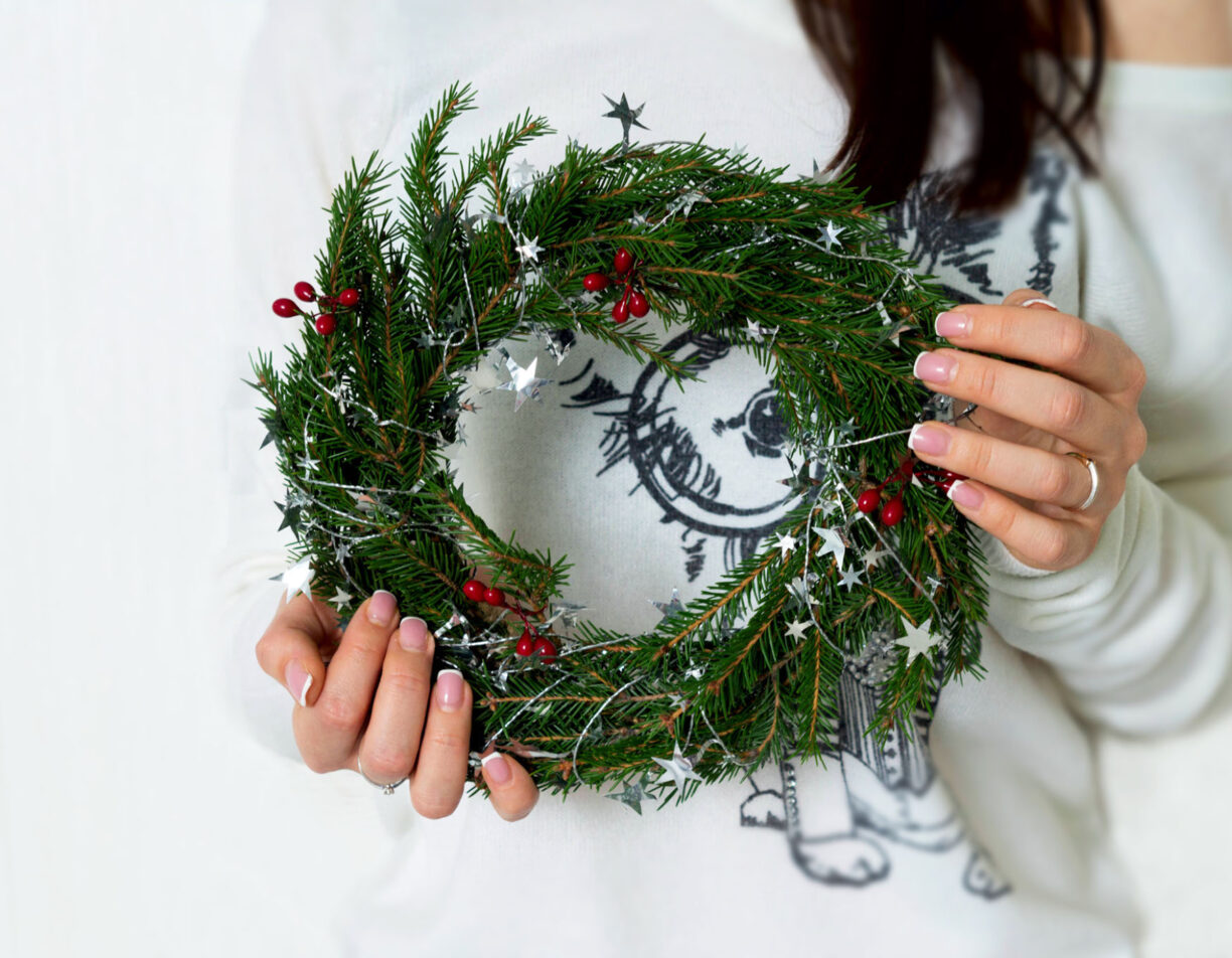 Woman holding a christmas wreath.