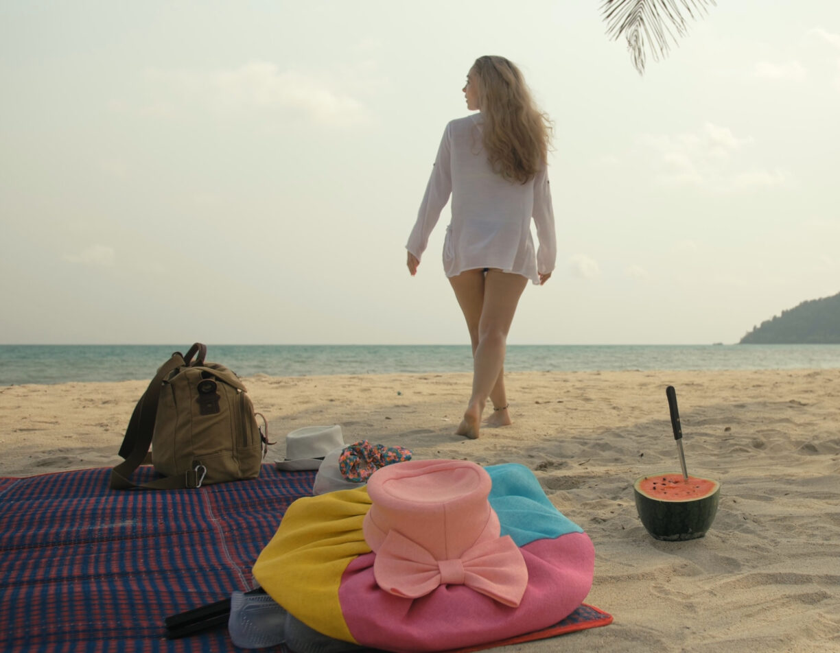 Woman walking towards the sea.