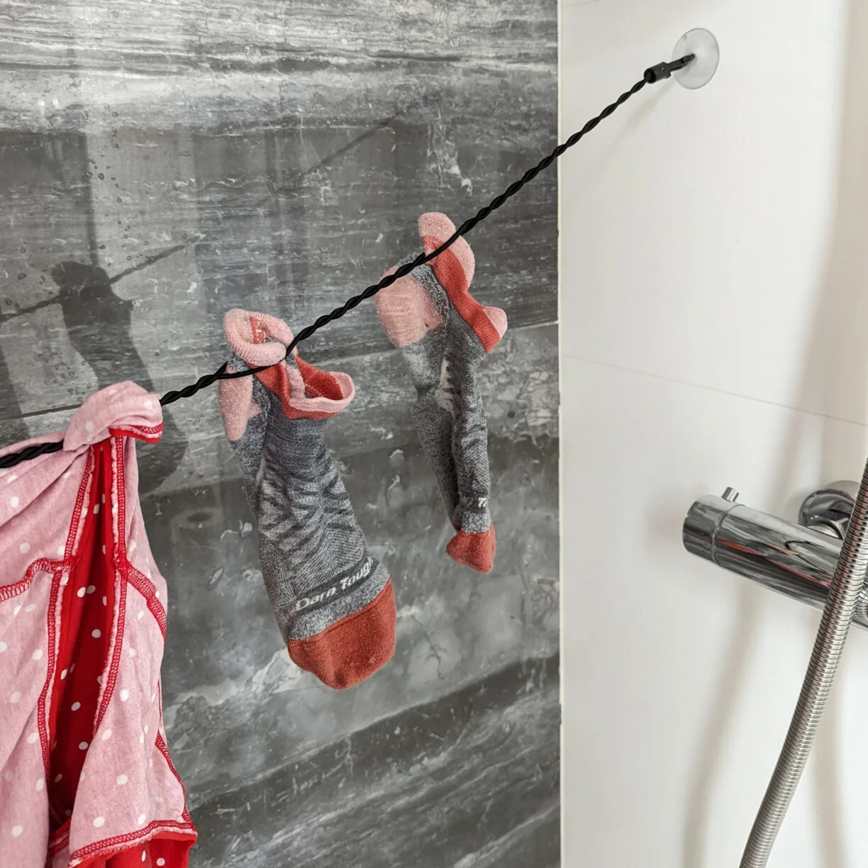 Socks drying on a travel clothesline using an alternative