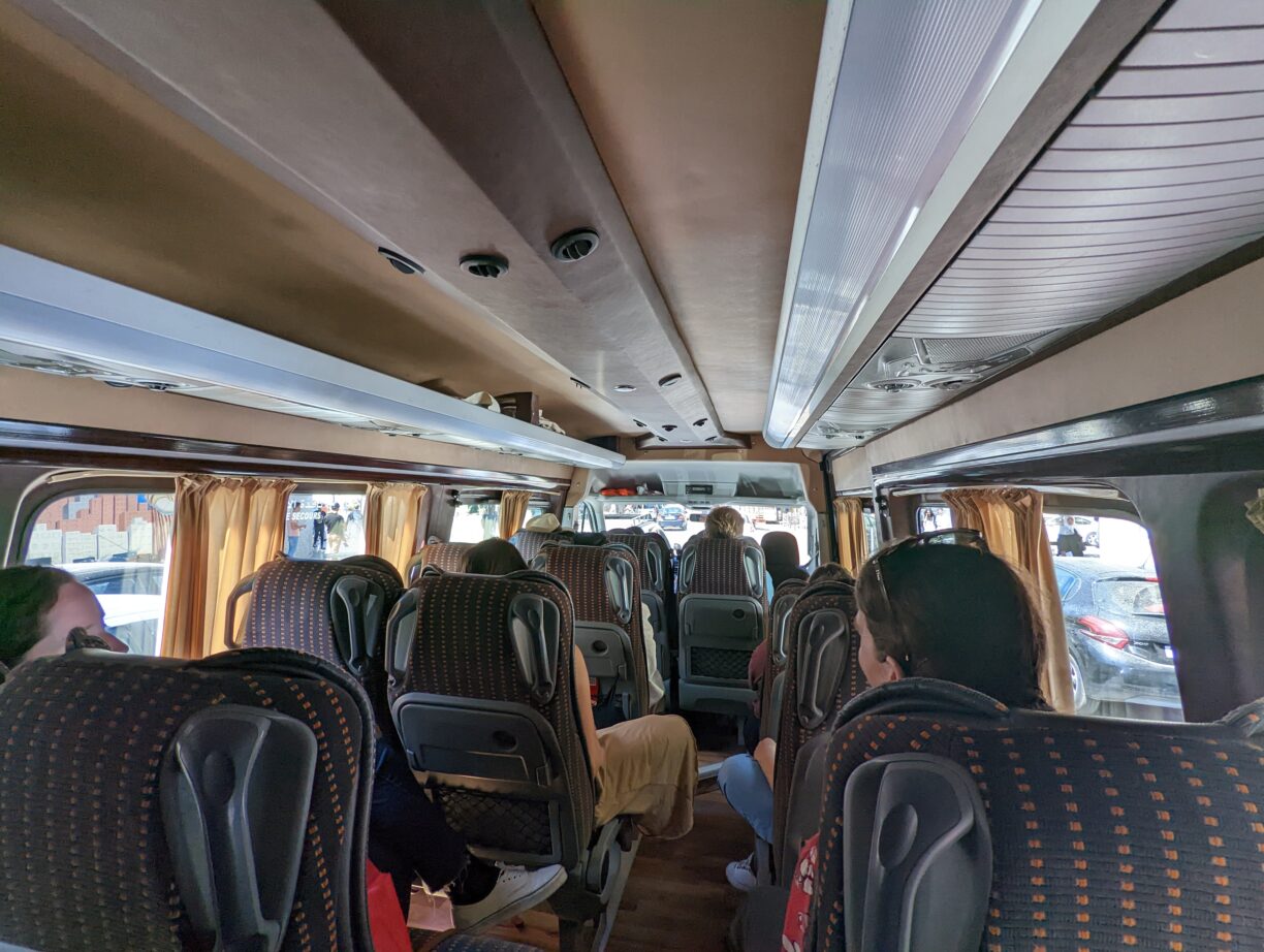 Travelers in an intrepid group tours tour van