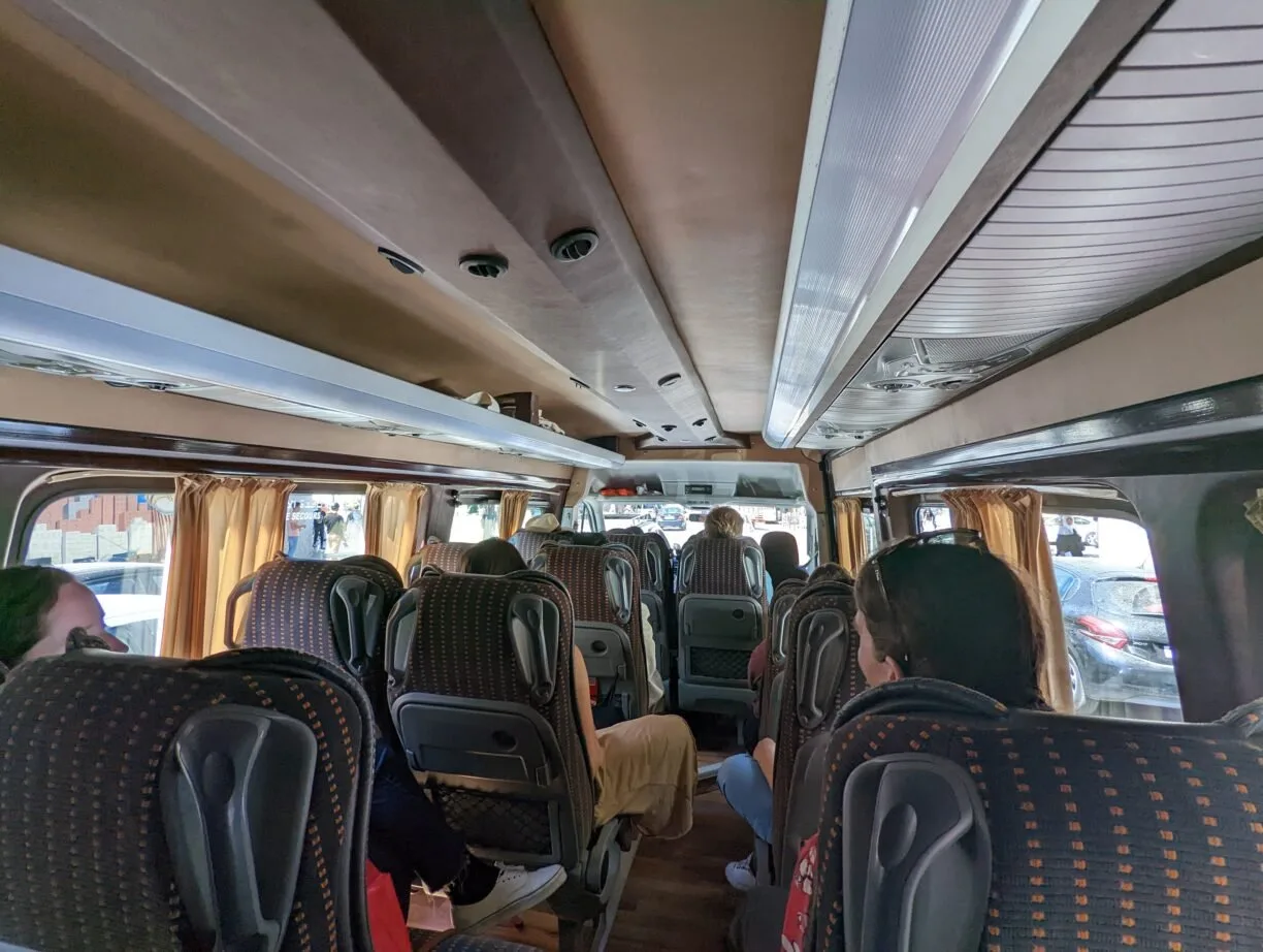 Travelers in an intrepid group tours tour van