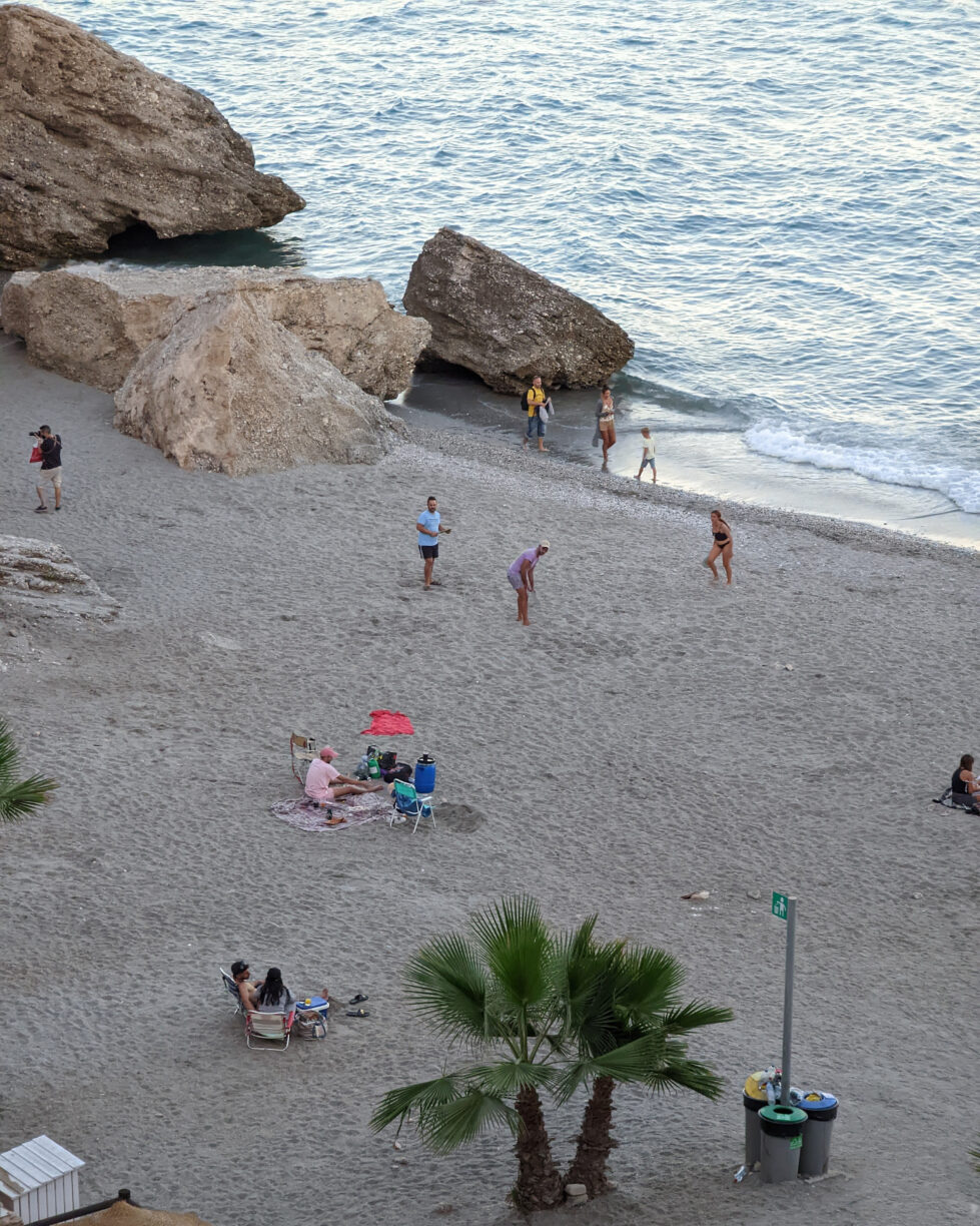 People enjoying typical beach activities on a beach in southern spain.