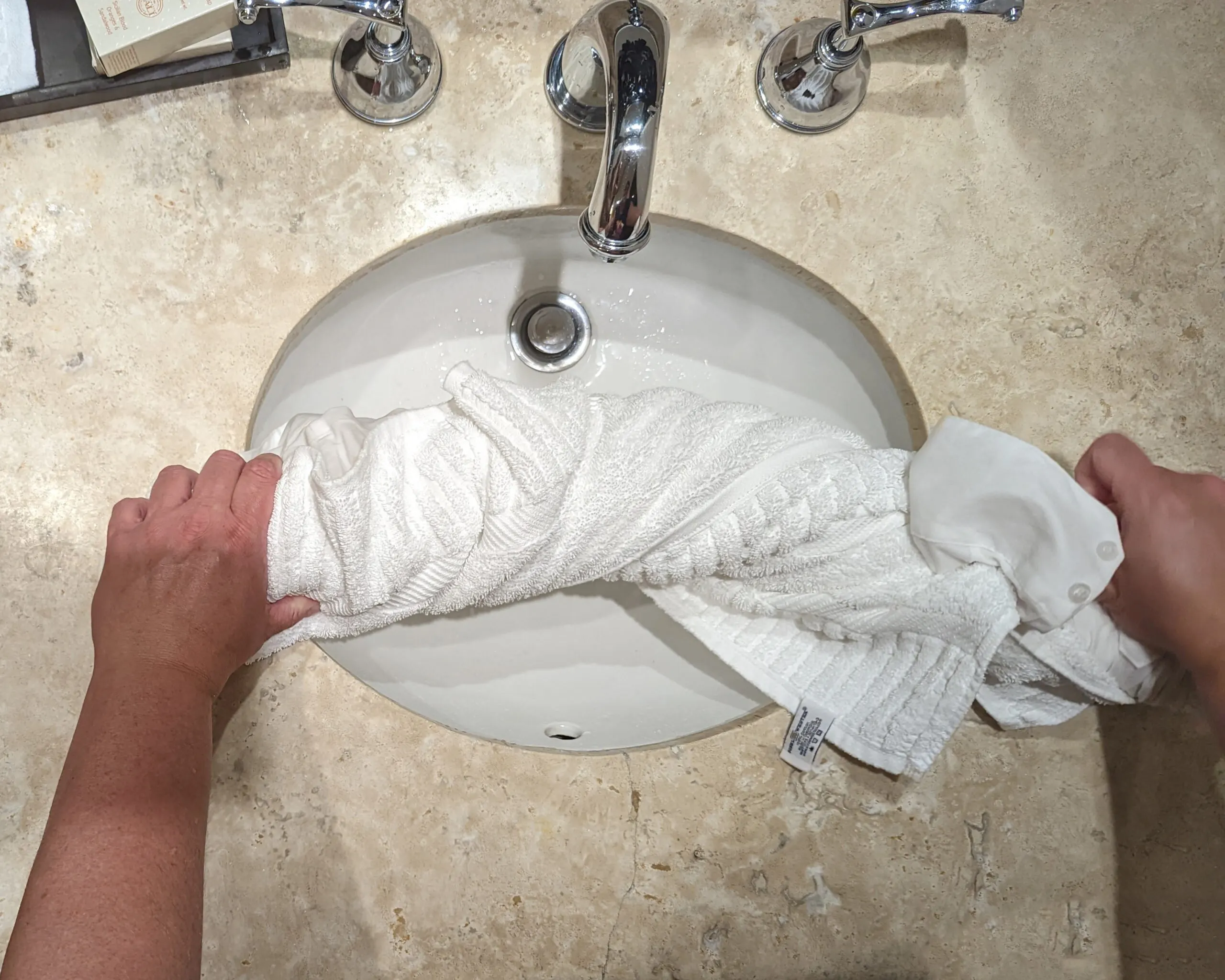 Rolling a wet shirt in a towel to dry.