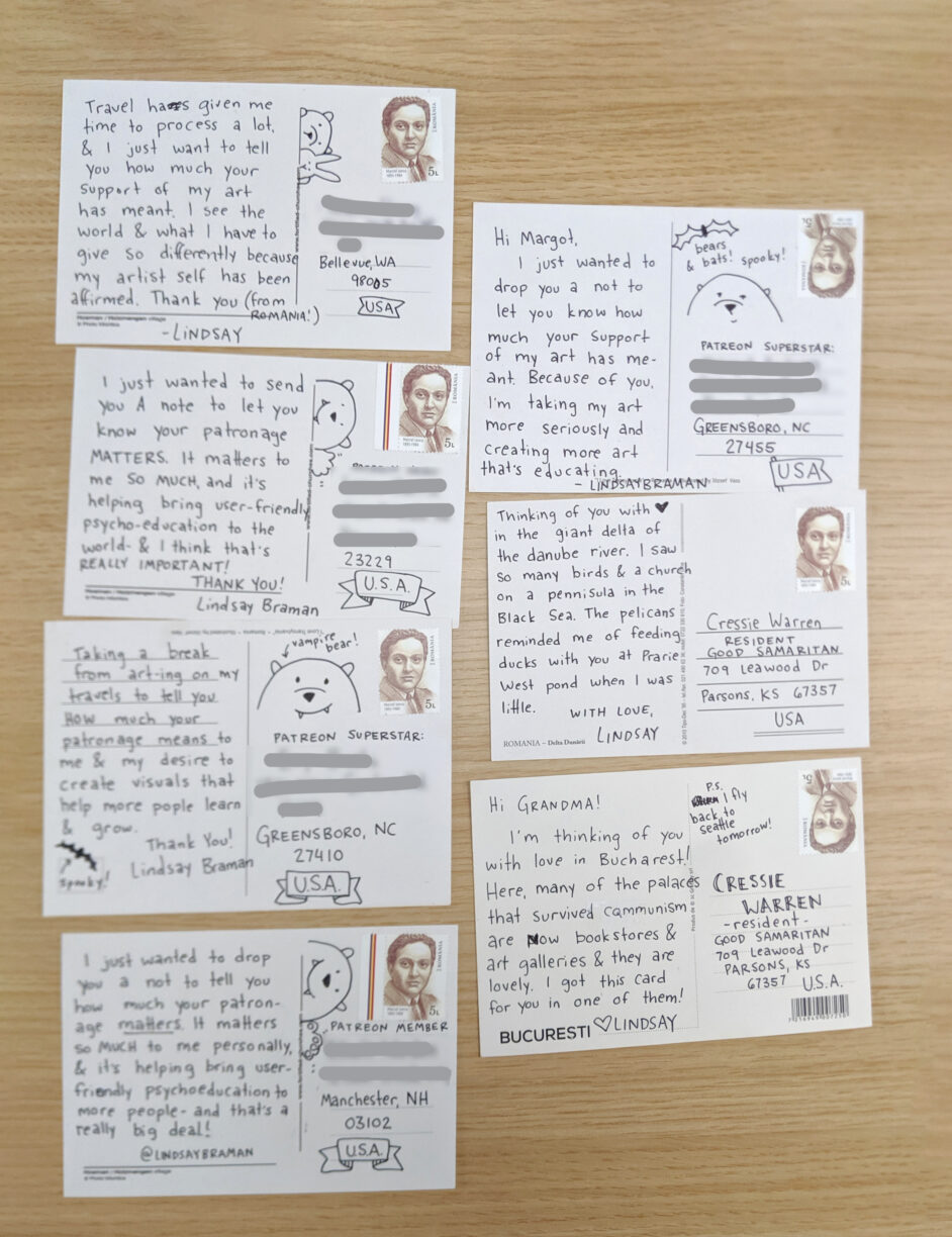 7 postcards laying on a table written and ready to mail.