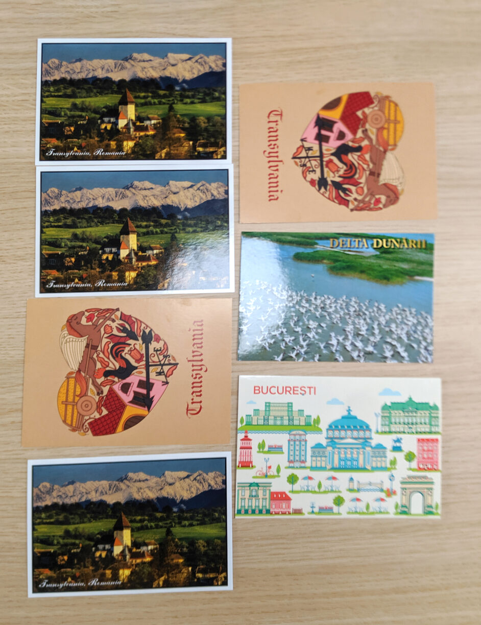 8 postcards laying on a table.