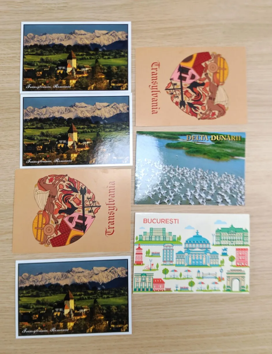 8 postcards laying on a table.