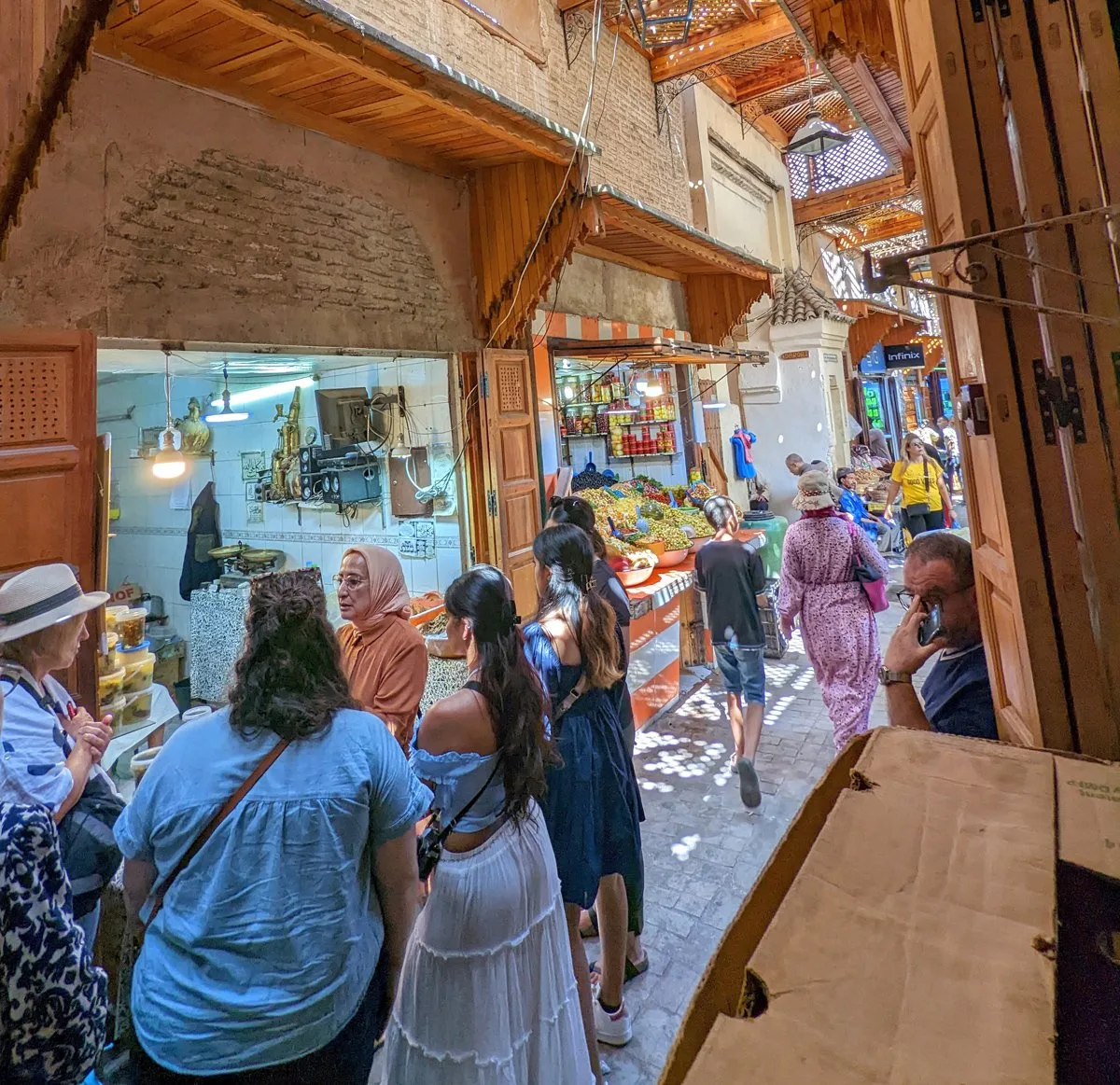 A tour group explores a medina in morocco.