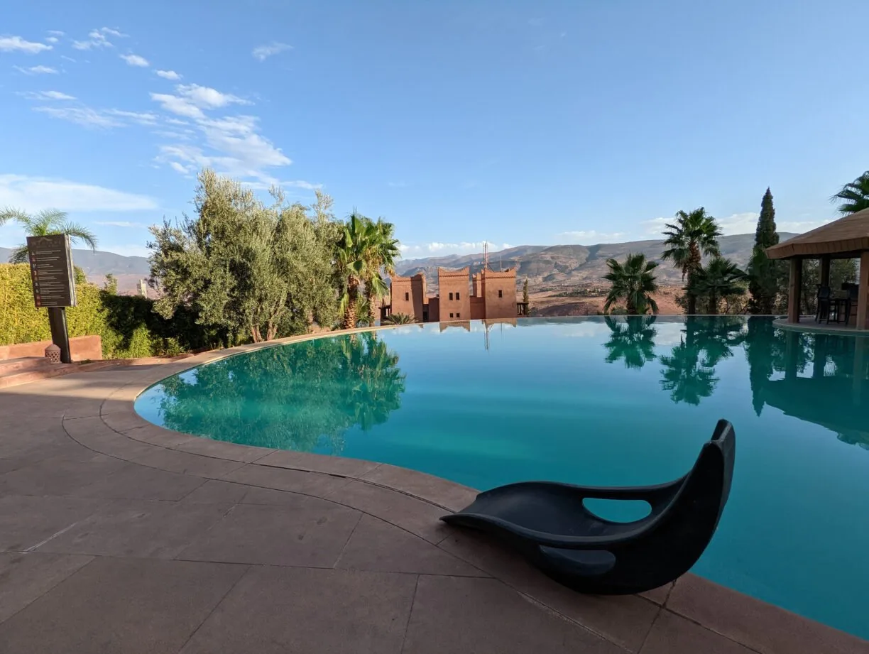Of poolside lounger next to an infinity pool in the atlas mountains of morocco.