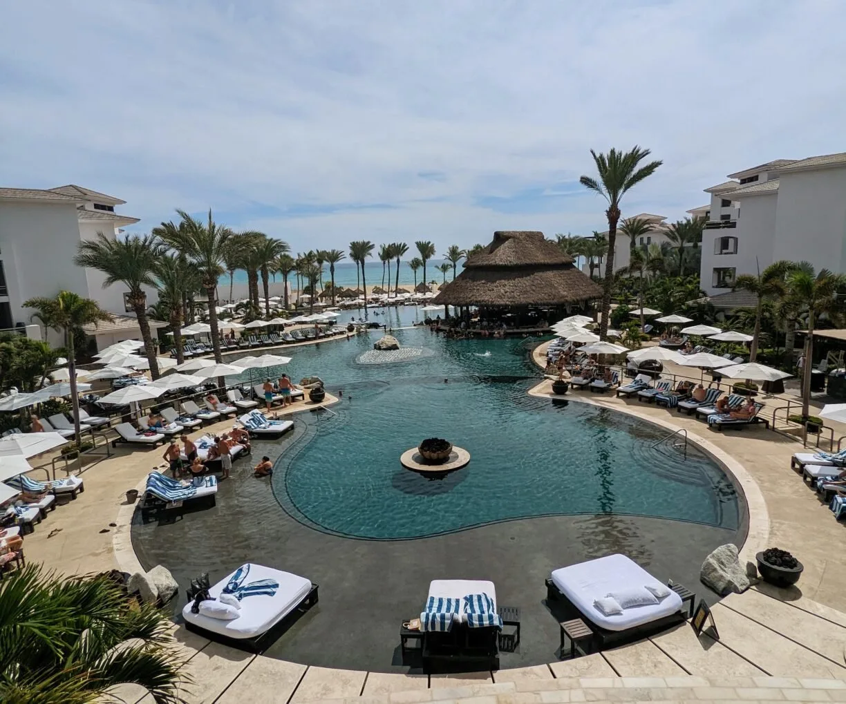 A sweeping view of a resorts poolside loungers.