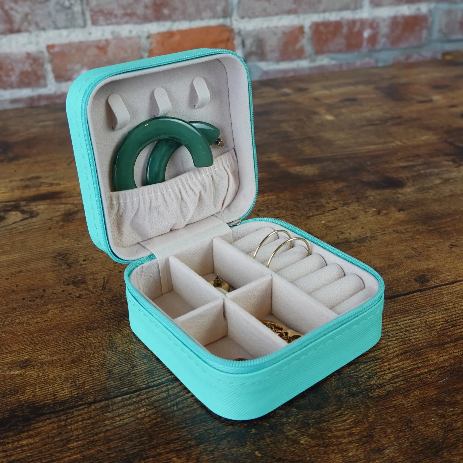 A turquoise jewelry case designed for travel