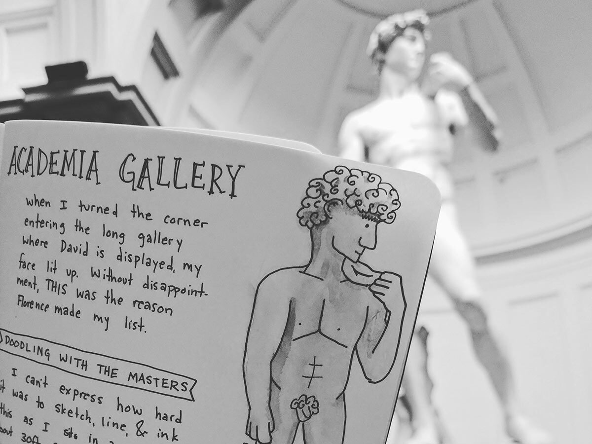 A dodle of the statue of david held in front of the statue of david in florence, italy.