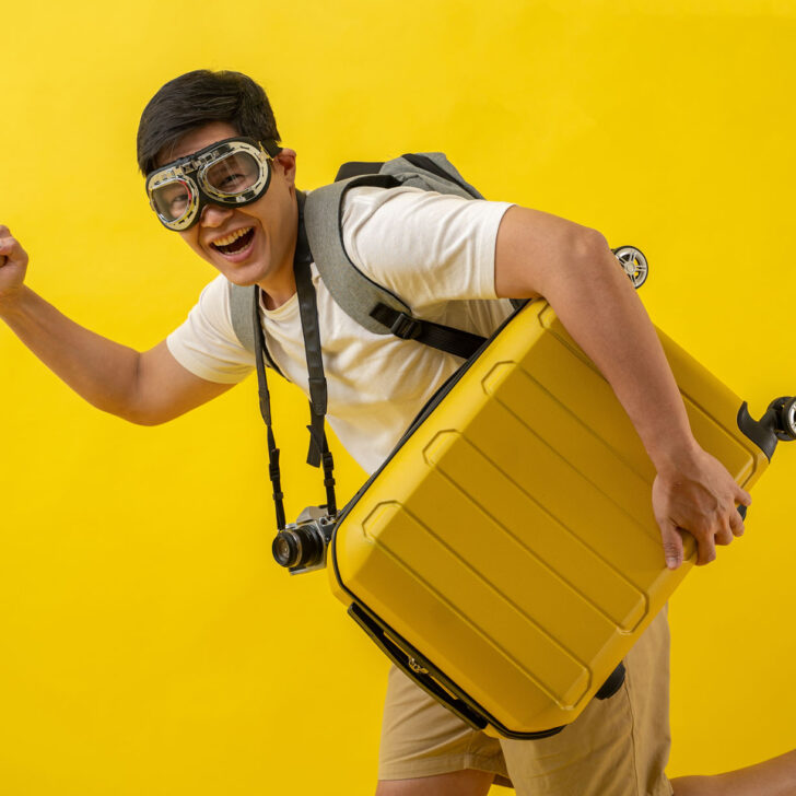 A man dressed in an over the top tourist costume.