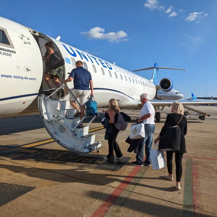 Passengers boarding a small united airlines jet.