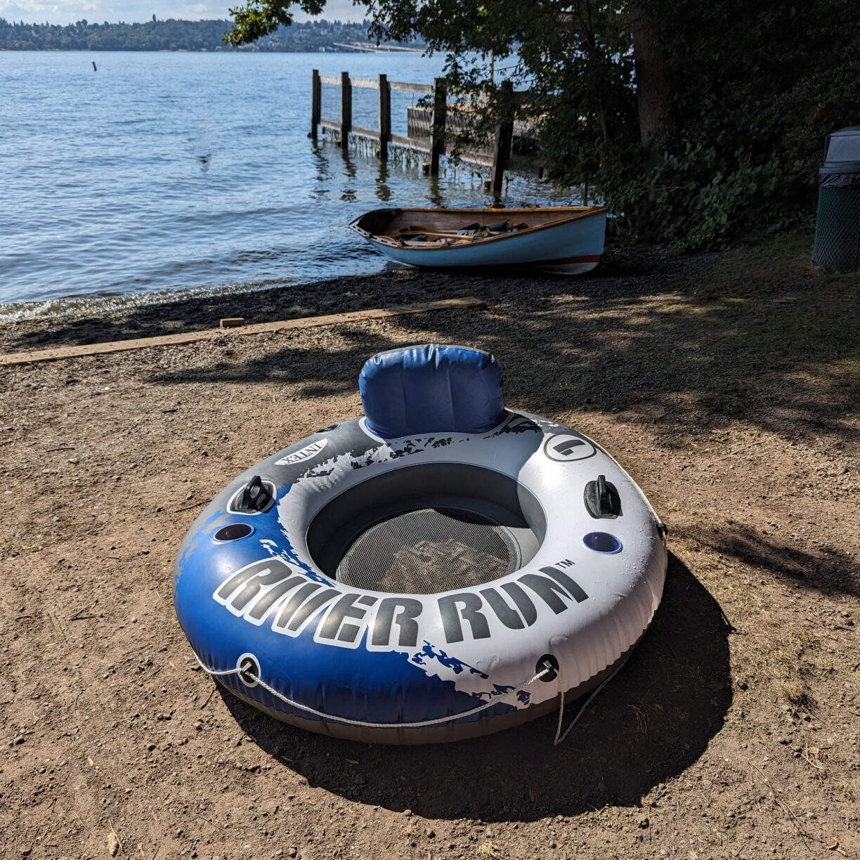 Large donut shaped pool float with handles and cup holders.