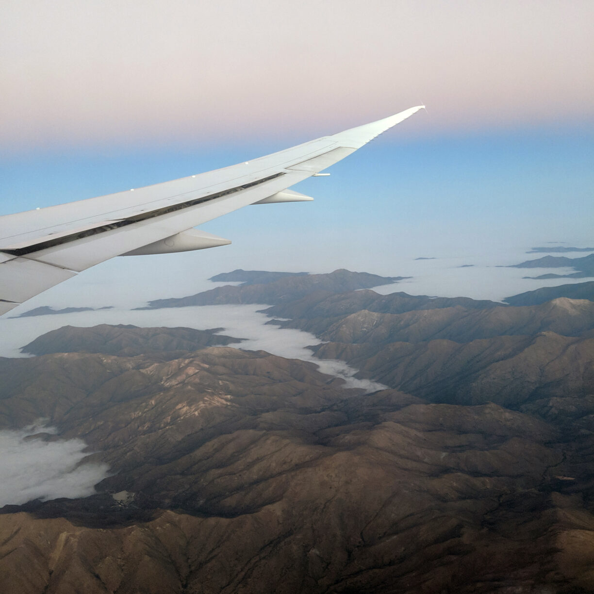 An airplane wing on a candy cane sky backdrop