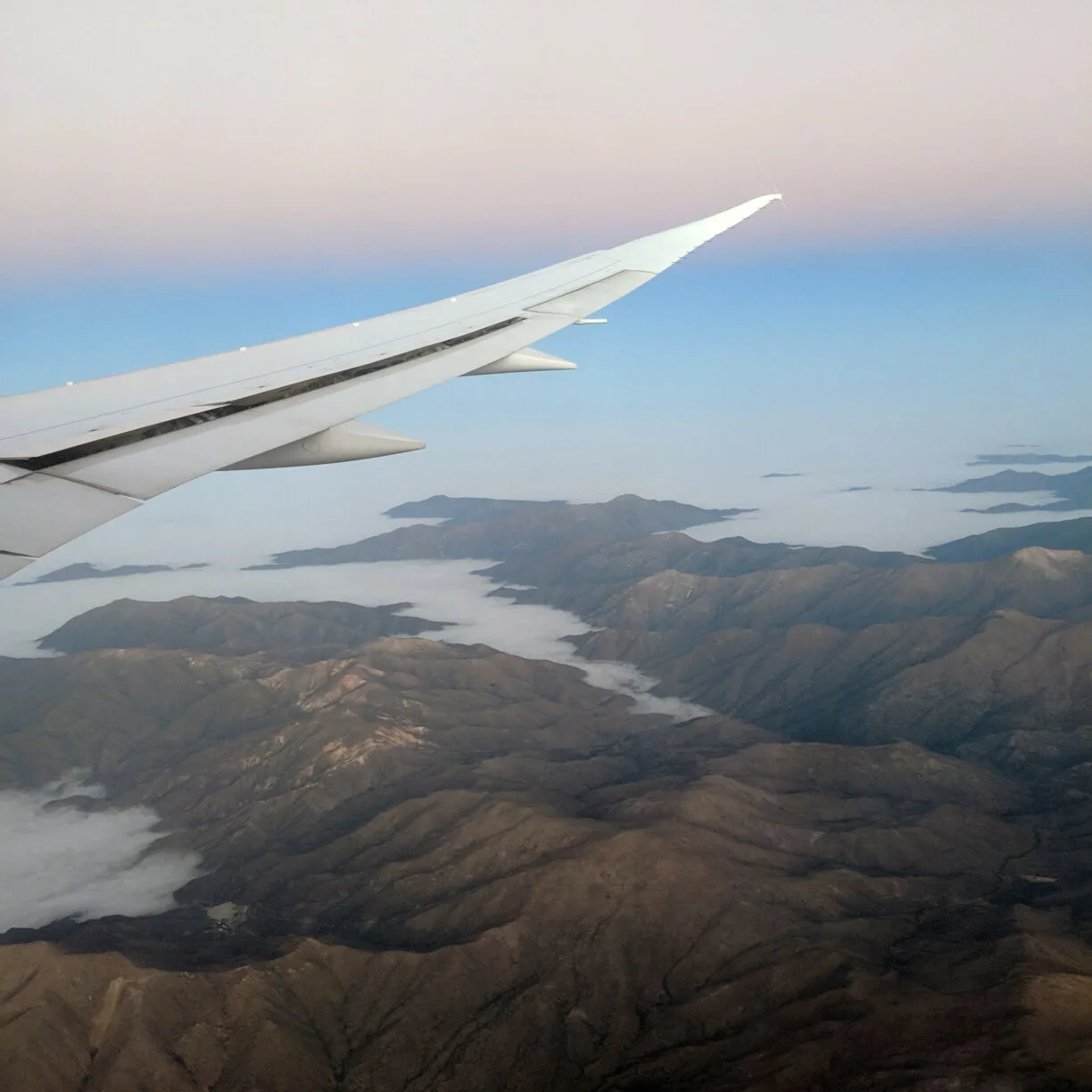 An airplane wing on a candy cane sky backdrop