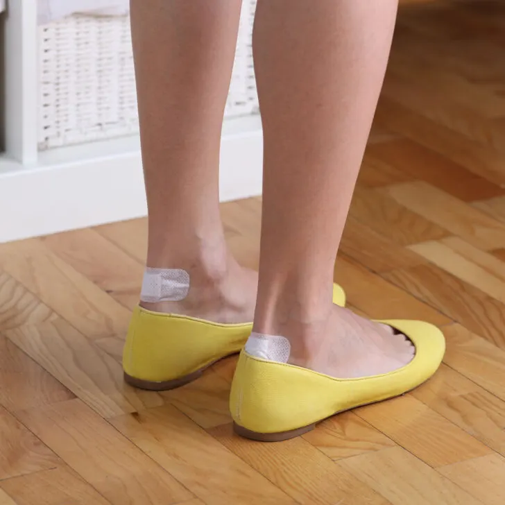 traveler wearing yellow shoes with blisters.