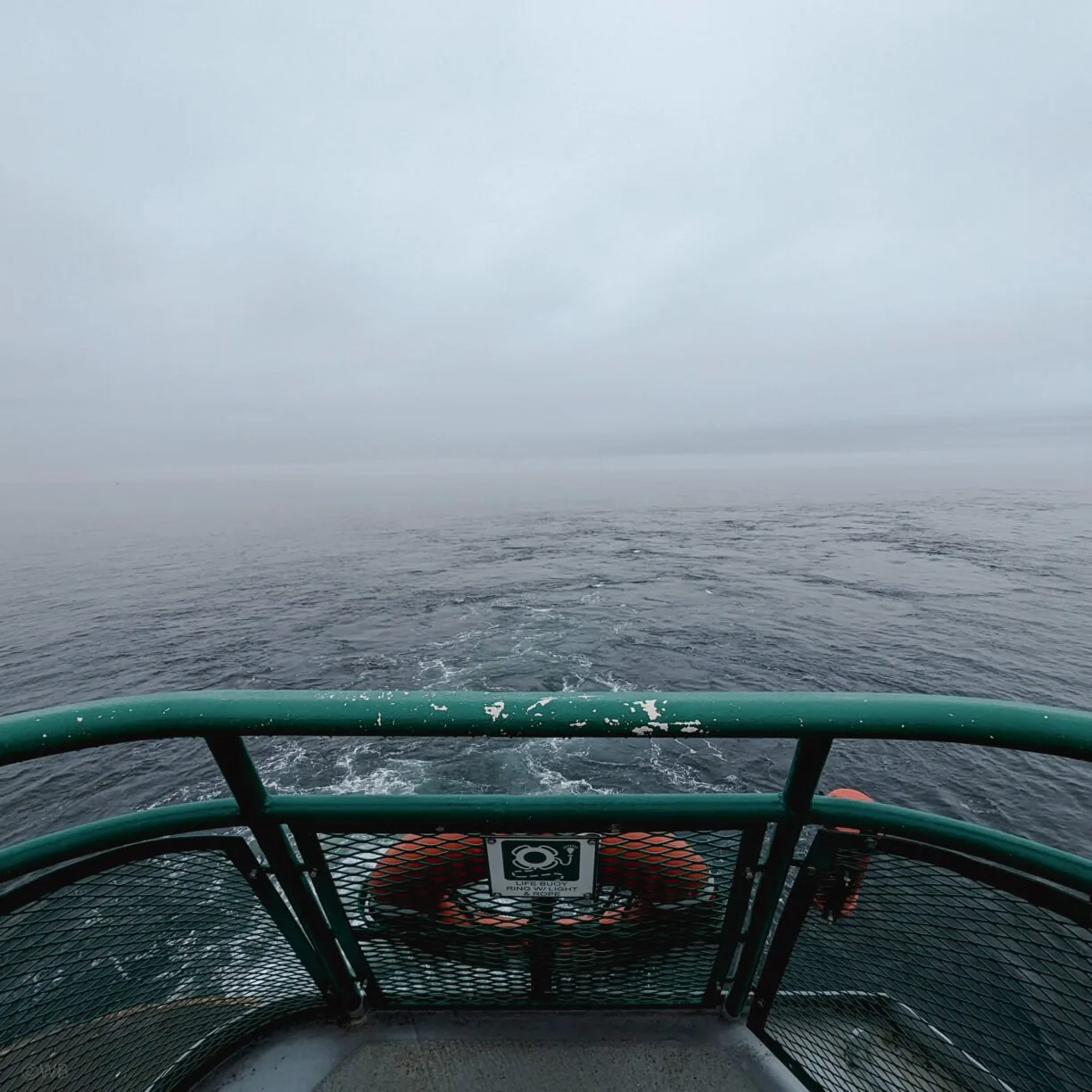 A foggy view from the deck of a washington state ferry.